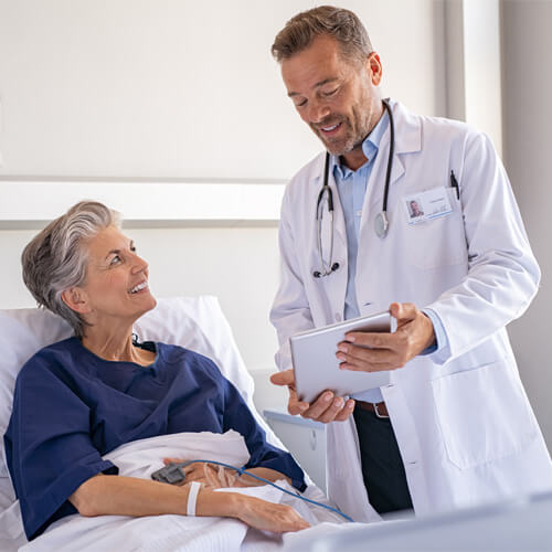 Doctor Holding the Tab and gives instruction to patient